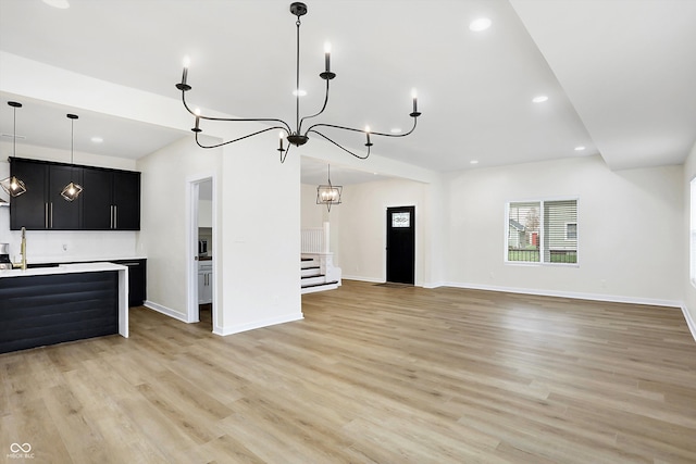 kitchen featuring hanging light fixtures, light hardwood / wood-style floors, and sink