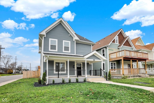 view of front of property with covered porch and a front yard