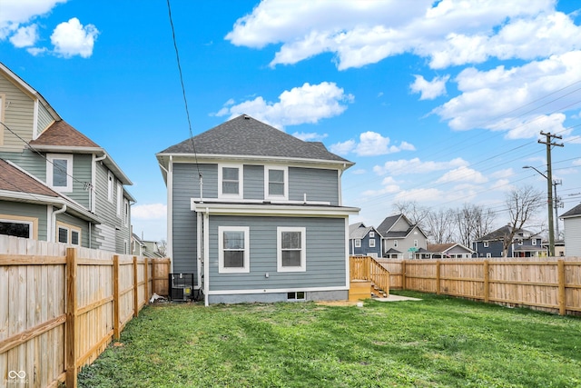 rear view of property featuring a yard