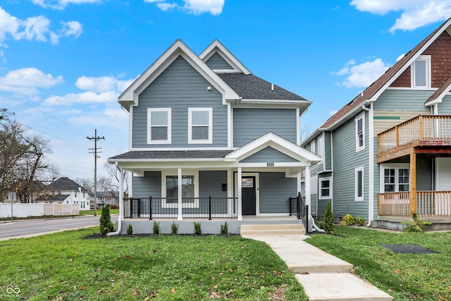 view of front of property with covered porch and a front yard