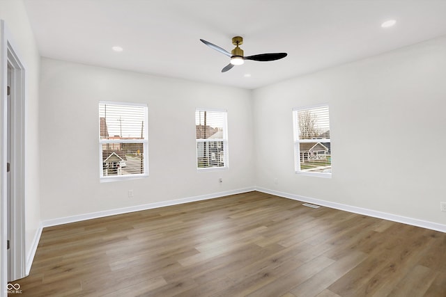 unfurnished room with ceiling fan and dark hardwood / wood-style flooring