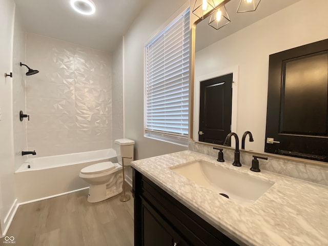 full bathroom featuring hardwood / wood-style floors, vanity, toilet, and shower / bath combination