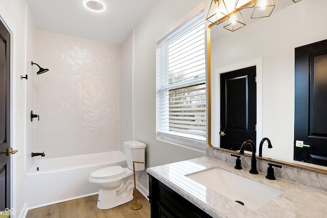 full bathroom with hardwood / wood-style floors, vanity, a healthy amount of sunlight, and toilet