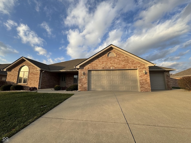 single story home with a garage and a front lawn