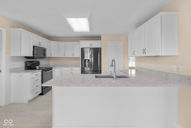 kitchen featuring sink, white cabinets, and stainless steel appliances