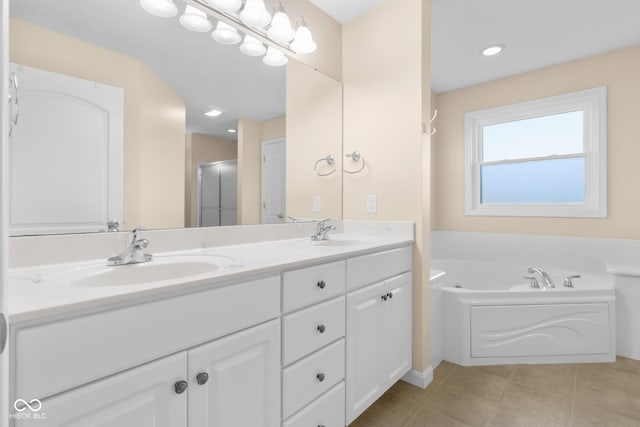 bathroom featuring tile patterned floors, vanity, and separate shower and tub