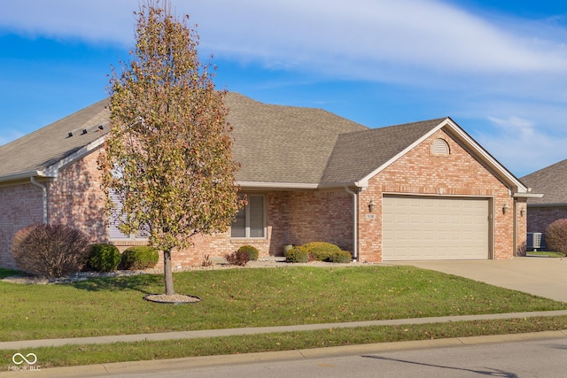 view of front of home featuring a front yard and a garage