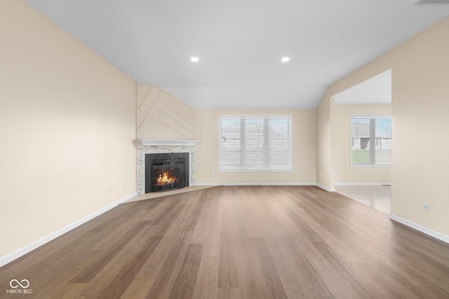 unfurnished living room with light hardwood / wood-style flooring and vaulted ceiling