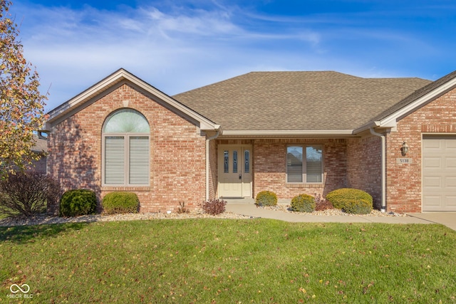 single story home with a garage and a front lawn