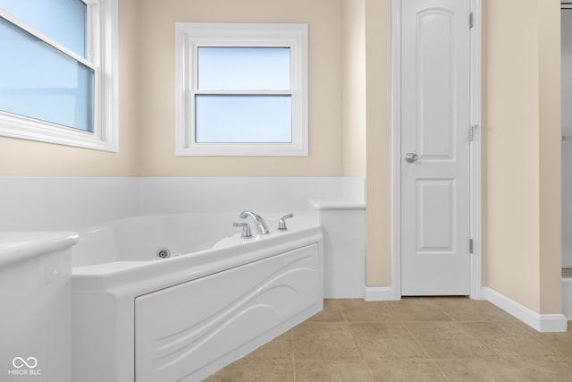 bathroom featuring tile patterned flooring and a tub