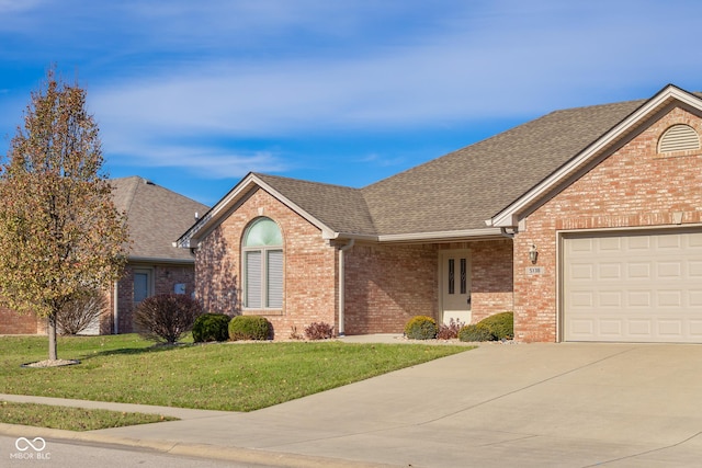 view of front of home with a garage and a front lawn