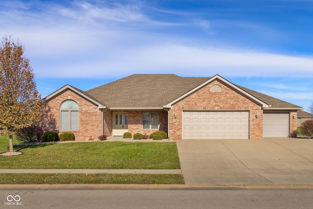 ranch-style house with a front yard and a garage