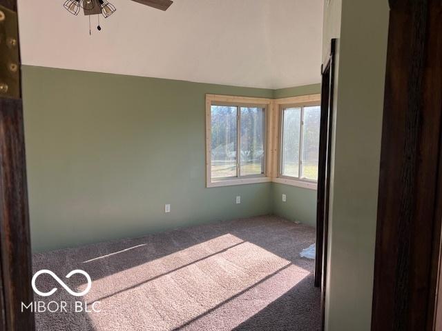 unfurnished bedroom with carpet floors and ceiling fan