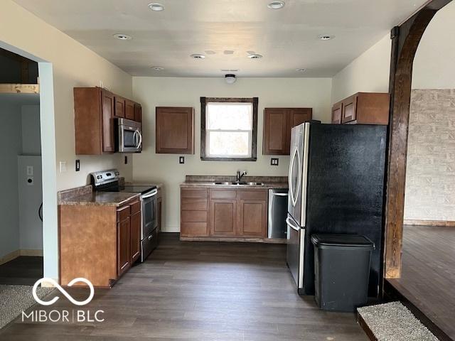 kitchen featuring stainless steel appliances, dark hardwood / wood-style floors, and sink