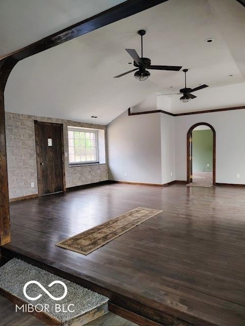 empty room featuring ceiling fan, dark hardwood / wood-style flooring, and vaulted ceiling