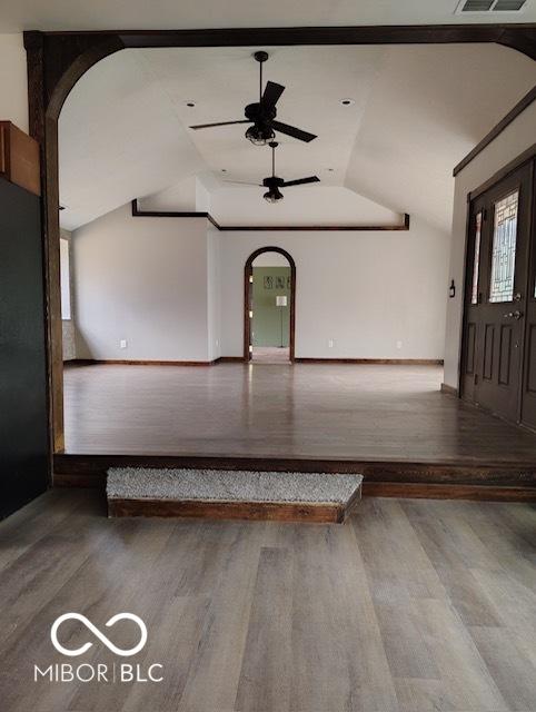 entrance foyer with hardwood / wood-style floors, vaulted ceiling, and ceiling fan