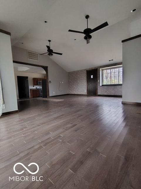 unfurnished living room with ceiling fan, high vaulted ceiling, and wood-type flooring