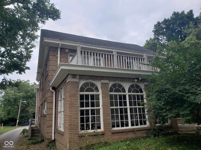 back of property with a balcony