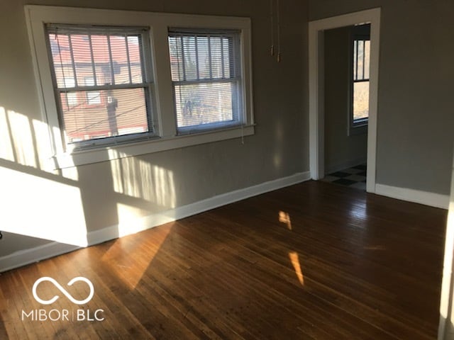 spare room featuring dark hardwood / wood-style floors