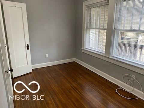 spare room with dark hardwood / wood-style flooring