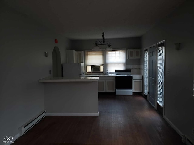 kitchen with a baseboard heating unit, white refrigerator, electric stove, hanging light fixtures, and white cabinetry