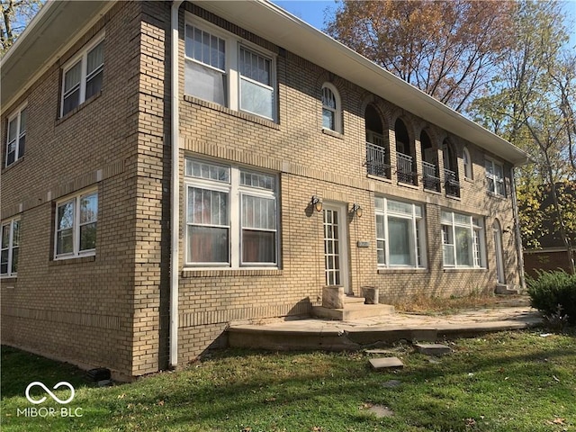 back of house with a lawn