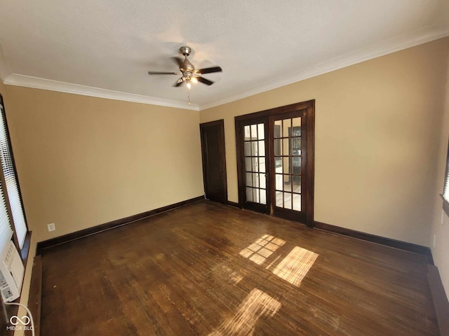 spare room featuring ceiling fan, ornamental molding, dark wood-type flooring, and french doors