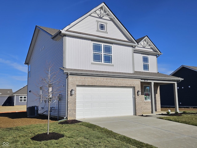 view of front of home with cooling unit, a garage, and a front lawn