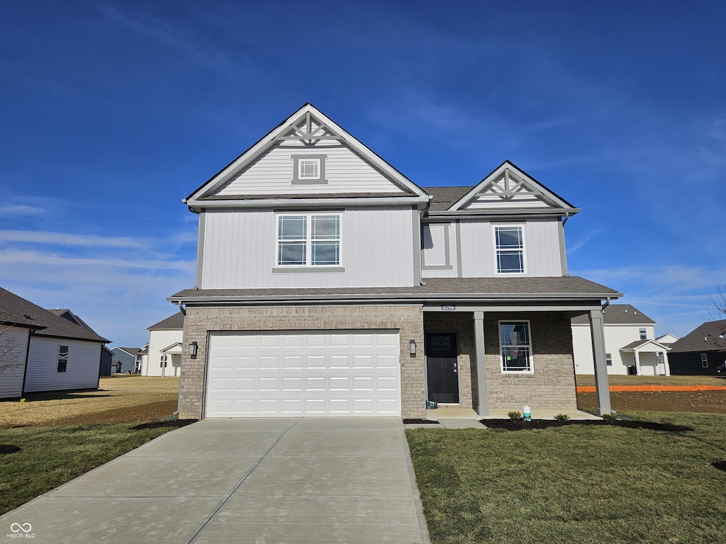 view of front of property with a garage and a front lawn