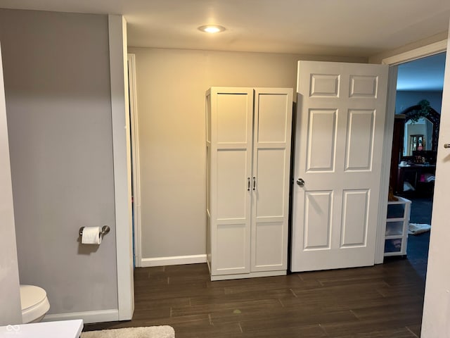 unfurnished bedroom featuring a closet and dark hardwood / wood-style flooring