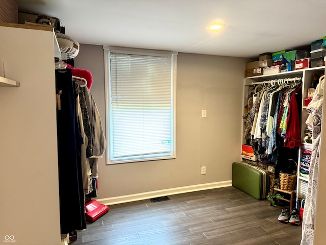 walk in closet featuring dark wood-type flooring