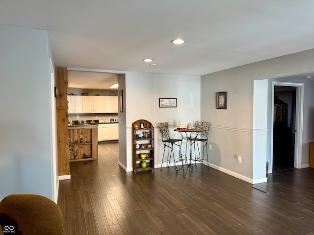 dining area with dark hardwood / wood-style flooring