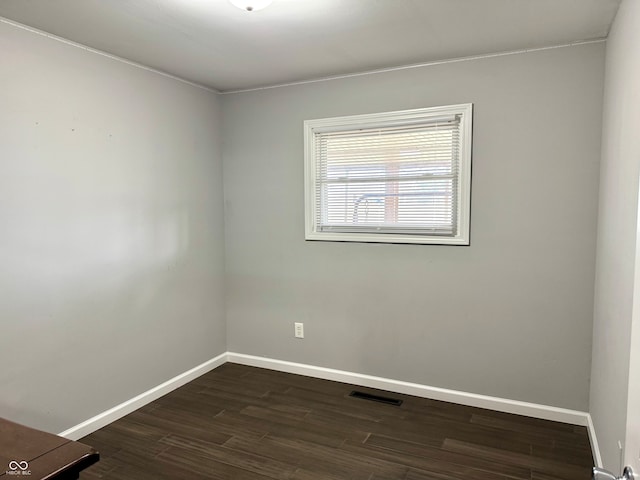 unfurnished room with dark hardwood / wood-style flooring