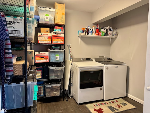 laundry room with washer and dryer and dark hardwood / wood-style flooring