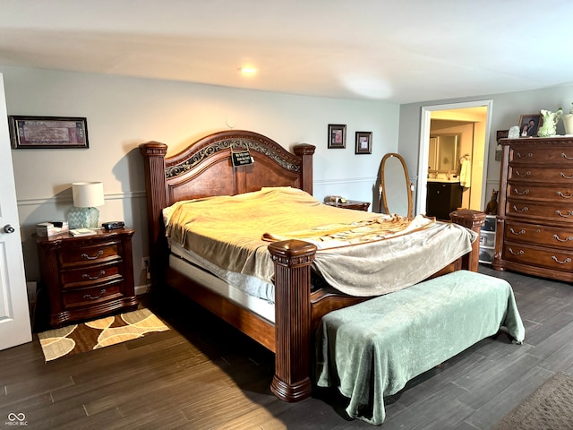 bedroom with dark hardwood / wood-style floors and ensuite bath