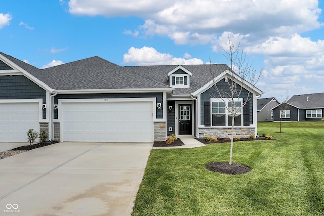 craftsman-style home with a garage and a front lawn