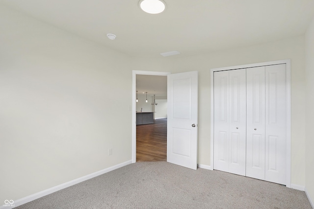 unfurnished bedroom with carpet floors and a closet