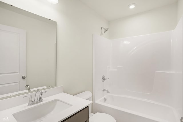 full bathroom featuring toilet, vanity, and  shower combination