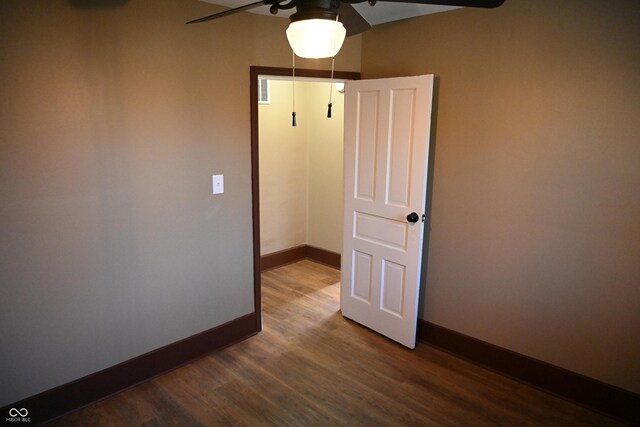 unfurnished room featuring ceiling fan and dark wood-type flooring