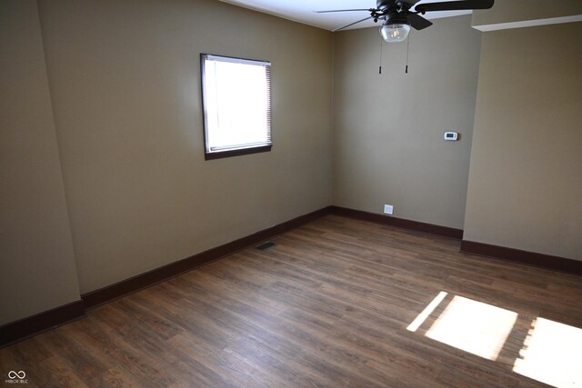 spare room with ceiling fan and dark hardwood / wood-style flooring