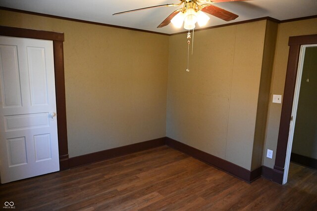 spare room featuring dark hardwood / wood-style floors, ceiling fan, and ornamental molding