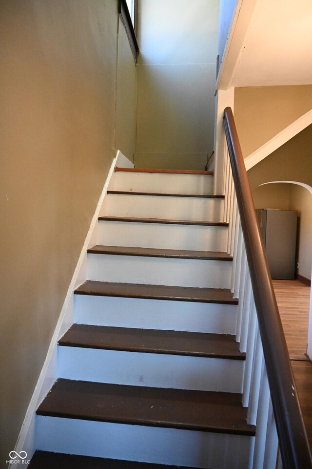 staircase with hardwood / wood-style floors