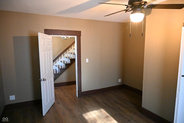 unfurnished bedroom with dark hardwood / wood-style flooring and ceiling fan