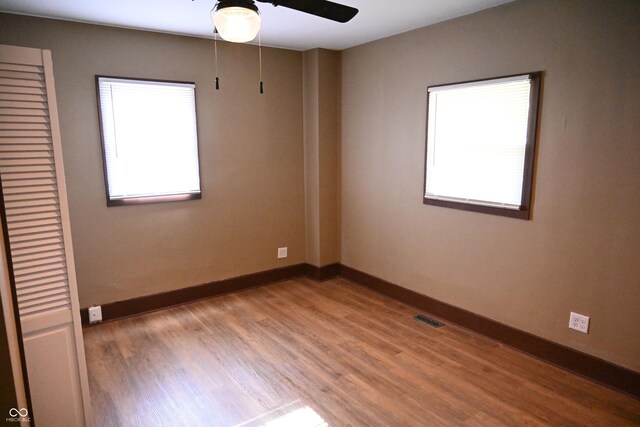 empty room featuring ceiling fan and light hardwood / wood-style flooring