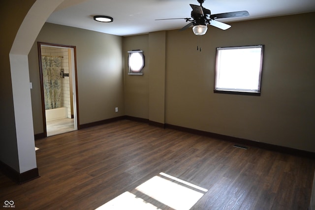 unfurnished room with dark hardwood / wood-style floors and ceiling fan