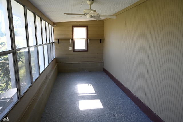 unfurnished sunroom with plenty of natural light and ceiling fan