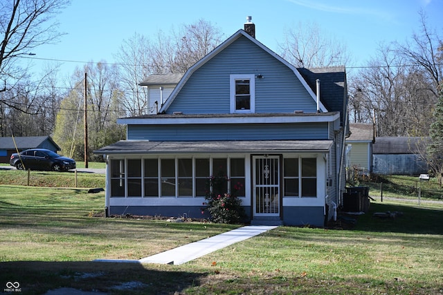 view of front of house featuring a sunroom, central air condition unit, and a front lawn