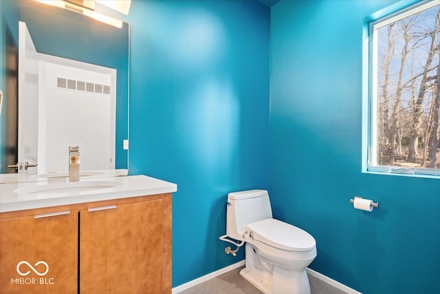 bathroom featuring vanity and toilet