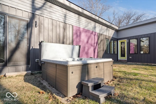 exterior space with a yard and a hot tub