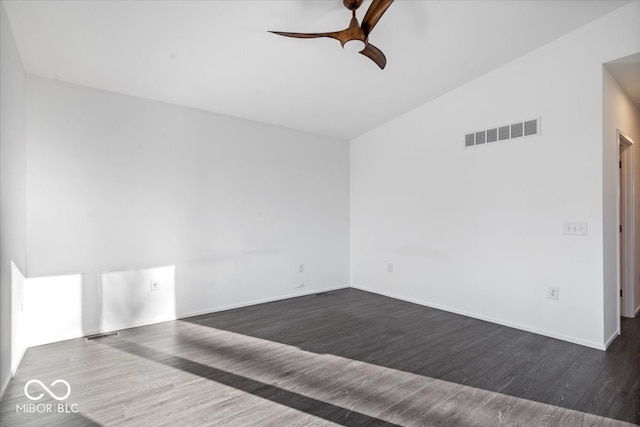 empty room with dark hardwood / wood-style flooring, high vaulted ceiling, and ceiling fan